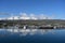 Akureyri, Iceland and surroundings reflected in calm water on sunny autumn day.