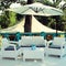 Al fresco cafe with white rattan wicker armchairs and tables on