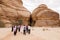 Al Ula, Saudi Arabia, February 19 2020: Tourists run to the entrance of the Siq Jabal Ithlib in Al Ula, KSA