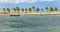 Alagoas/Brazil - Apr.13.19: empty canoe, palm trees, beach and waters of san francisco river