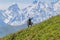 ALAMEDIN, KYRGYZSTAN - MAY 21, 2017: Herdsman on a horse with his dog at a pasture in Alamedin valle