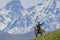 ALAMEDIN, KYRGYZSTAN - MAY 21, 2017: Herdsman on a horse at a pasture in Alamedin valle