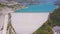 Alanya Dim dam. Clip. Top view of large dam holding back water in mountains. Turquoise water in reservoir with large dam