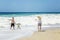 Alanya, Turkey, 05/07/2019: A family is photographed on a sandy beach against the backdrop of a raging sea. happy holidays