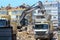 Alanya, Turkey - june 05 2019, excavator and truck working on the destruction of an old building next to houses in the city