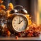 Alarm clock with autumn foliage, end of daylight saving time in fall, winter time changeover