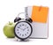Alarm clock, blank notebook sheet and apple.