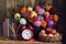 Alarm clock, bouquet, apples in basket and books on the table. R