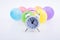 Alarm clock and colorful small Balloons