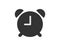 Alarm clock in flat design with black color. Timer or watch reminder in simple style. Isolated icon of stopwatch in