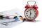 Alarm clock, over pile various documents Deadline business and finance concepts