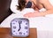 Alarm clock before ringing. Man in eye mask sleep better. Guy prefer relax in darkness. Alarm clock on bedside table man