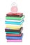 An alarm clock on top of stack of colorful books