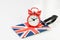 Alarm clock on Union jack, United Kingdom national flag luggage label using as countdown on Brexit England withdrawal from Euro