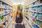 Alarmed female wears medical mask against coronavirus while grocery shopping in supermarket or store- health, safety and
