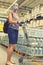 Alarmed female wears medical mask against coronavirus while shopping in supermarket or store- health, safety and pandemic concept