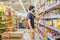 Alarmed man wears medical mask against coronavirus while grocery shopping in supermarket or store- health, safety and