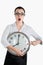 Alarmed, shocked business woman holding a large clock. White iso