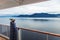 Alaska cruise travel luxury vacation woman watching inside passage scenic cruising day on balcony deck enjoying view of