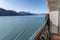 Alaska cruise travel tourist looking at mountains landscape from balcony deck of ship. Inside passage Glacier bay scenic