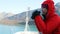 Alaska Glacier Bay Tourist looking at landscape using binoculars on cruise ship