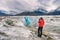 Alaska glacier hike walk tour woman tourist hiker taking pictures on cruise ship excursion