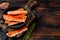 Alaskan King Crab legs Phalanx in a pan with herbs. Dark wooden background. Top view. Copy space