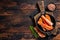 Alaskan King Crab legs Phalanx in a pan with herbs. Dark wooden background. Top view. Copy space