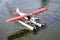 An Alaskan seaplane is floating on the Chena River getting ready for taking off.