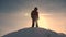 Alaskan traveler go to the top of a snowy hill and rejoice in victory against a winter sunset. Mountaineer Journey to