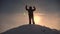 Alaskan traveler go to the top of a snowy hill and rejoice in victory against a winter sunset. Mountaineer Journey to