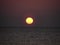 Alassio Beach the Orange sun is setting over the sea