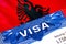 Albania Visa in passport. USA immigration Visa for Albania citizens focusing on word VISA. Travel Albania visa in national