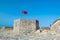 Albanian flag flies over Ali Pasha Tepelena Fortress Porto Palermo. Albania