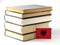 Albanian flag with pile of books on white background