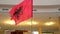 The Albanian flag sways with pride indoors
