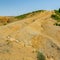 Albanian nature landscape. Sandy hills with rainwater sign on the soil