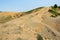 Albanian nature landscape. Sandy hills with rainwater sign on the soil