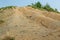 Albanian nature landscape. Sandy hills with rainwater sign on the soil