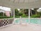 ALBANY, NASSAU. BAHAMAS - JULY 21, 2018. White bench, gazebo in a pool in the garden of a luxury resort