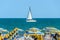 ALBENA, BULGARIA - JUNE 17, 2017: Wind boat yacht on blue Black Sea water near beach with tourists.