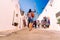 Alberobello, Italy - March 9, 2019: Tourist guide guiding a group of visitors from the beautiful city of Alberobello travel