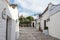 Alberobello, Puglia, Italy - June 26, 2019: Street in the village of Trulli with white houses with conical stone roofs