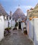 Alberobello, Puglia, Italy. Traditional dry stone conical roofed trullo house with pumpkins for halloween.