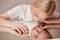 Albino feminine blonde haired boy model reflected in mirror table