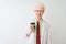 Albino scientist man wearing glasses drinking take away coffee over isolated white background with a happy face standing and