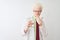 Albino scientist man wearing glasses holding glass of water over isolated white background cover mouth with hand shocked with