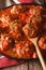 Albondigas meatballs with spicy sauce on a dish close-up. vertical