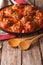 Albondigas meatballs with tomato sauce on a plate close-up. Vert