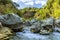 The Alcantara river cascades around large volcanic boulders which line the riverbed near Taormina, Sicily